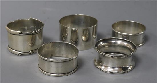 Five assorted silver napkin rings.